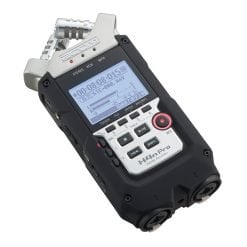 Professional portable audio recorder with multiple inputs and display screen showing recording status.