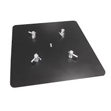 A black metallic plate with various screws and fasteners scattered across its surface.
