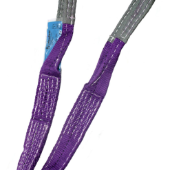 Purple flat webbing sling with reinforced loops used in climbing or industrial rigging lying isolated on a white background.