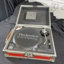 A classic Pair of Ex-Hire Technics 1210 Mk2 vinyl turntables, housed in sturdy, protective flight cases, ready for the DJ's next gig.