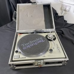 A Pair of Ex-Hire Technics 1200 Mk2 vinyl turntables inside a protective carrying case, ready for transport or a DJ's use.